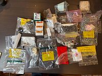 Spread of multiple bags containing screws, standoffs, washers, and semiconductor bags