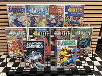 Front covers of all ten bagged comics displayed on rack