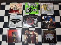Nine CD cases laid out showing front cover art for each album listed
