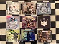 All nine CD cases laid out in 3x3 grid showing front cover artwork