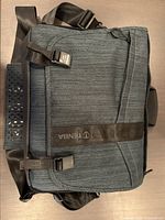 Front view of Tenba DNA 13 messenger bag showing flap, magnetic clasp and strap