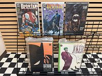 Full lot on display rack showing all five bagged and sleeved items