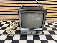 Front view of Sony 9-304W TV with control panel and DC adapter cord visible