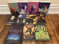 All eleven books laid out showing front covers and bindings