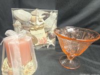 Group shot of pink candle, seashell package, and depression glass dish