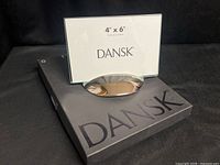 Frame displayed on top of box showing size card and polished metal base