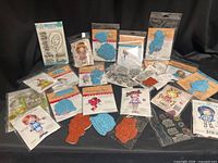 All 20 packaged rubber stamp sets spread on black cloth