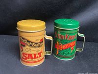 Front view of both salt and pepper tins