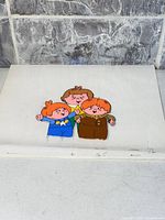 Full view of animation cel with three characters and production numbers visible