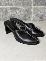 Side view of both shoes showing uppers, heels and stitching