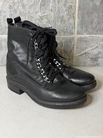 Side view of both black leather Aldo boots