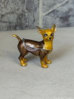 Front right view of enamel Chihuahua trinket box showing gold paws, facial detail and rhinestone hinge line