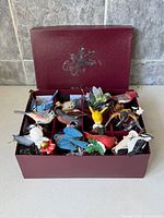 Presentation box open showing all 12 bird ornaments in individual compartments