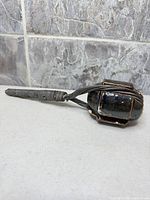 Full view of ceramic sculpture showing handle and head