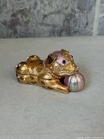 Dog-shaped jeweled trinket box closed, front view