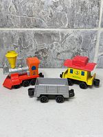 Group shot of all three Mattel toy train cars