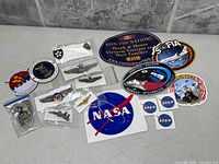 Full lot overview of military pins and NASA decals