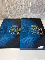Front view of atlas and slipcase side-by-side