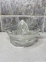 Side view showing pressed glass juicer pattern, handle, spout