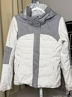 Front view of white and grey Roxy DryFlight snow jacket on hanger