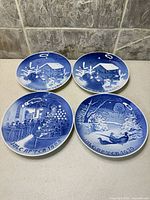 Group shot of all four blue white Christmas plates