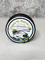 Front of puck showing St. Patrick's Day 2008 Sharks logo and Alexei Semenov autograph