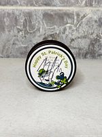 Front of puck showing Happy St. Patrick's Day graphic and Brian Campbell signature