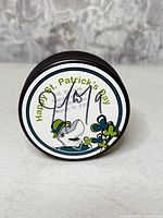 Front of puck showing St. Patrick's Day graphic and autograph