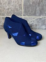 Side view of both navy blue United Nude ankle booties