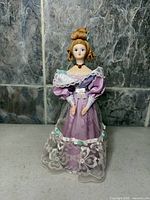 Front view of lavender cloth souvenir doll