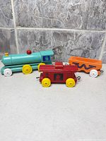 All three wooden toy train cars side by side showing overall appearance