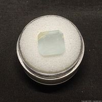 Loose milk green aquamarine in round gem case