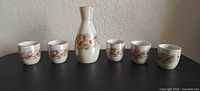 Full set showing 1 carafe and 5 cups with dragon motif