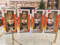 Group shot of four boxed 2002 Team Canada bobbleheads on table