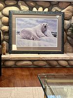 Front view of framed polar bear print on stone backdrop