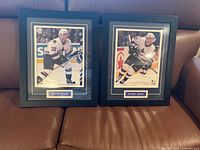 Both framed Sedin prints on sofa