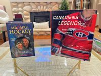 Both hardcover books on display stands
