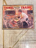 Close-up of first Lionel sign showing boy with dog and rail layout