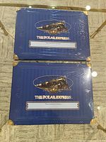 Front view of both sealed Polar Express memory boxes