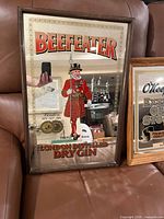 Beefeater mirrored sign showing guard graphic and text in wood frame