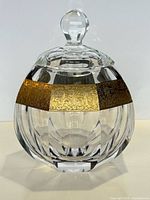 Full frontal view of lidded crystal jar showing overall form and gilt band