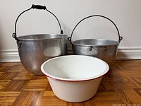 Group shot of two aluminum pots and enamel basin