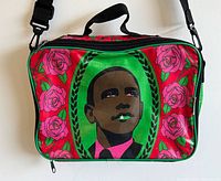 Front view of messenger bag showing Barack Obama portrait and rose motif