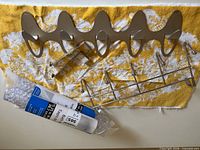 All items laid out: two racks, rolled bath mat, unrolled bath mat