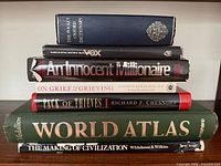 Stack showing all seven book spines for identification