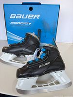 Full view of both skates in front of Prodigy box