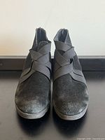 Front view of both boots showing suede texture and elastic straps