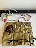 Full lot with roll-up case open showing instruments, ceramic holder, reflex hammer, headbands and speculum