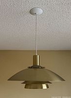 Full view of pendant lamp hanging from ceiling