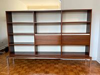 front view showing full shelving layout and drop-down cabinets